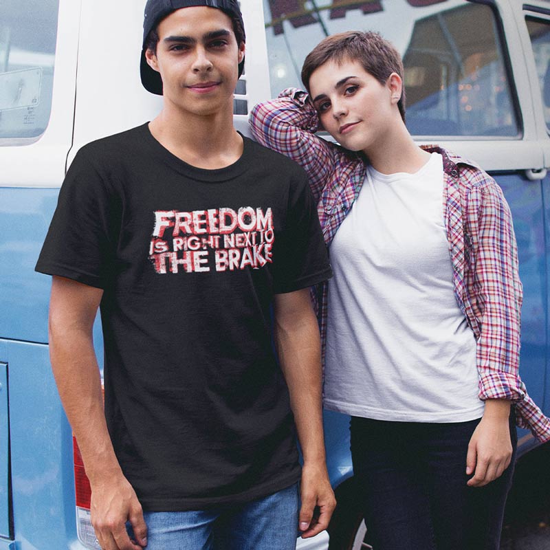 man and woman by van wearing racing shirt with freedom is right next to the brake typography