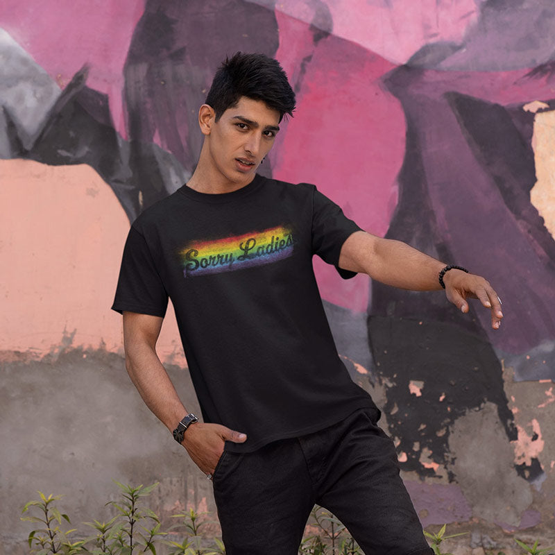 man in front of graffiti wearing rainbow t shirt with sorry ladies design