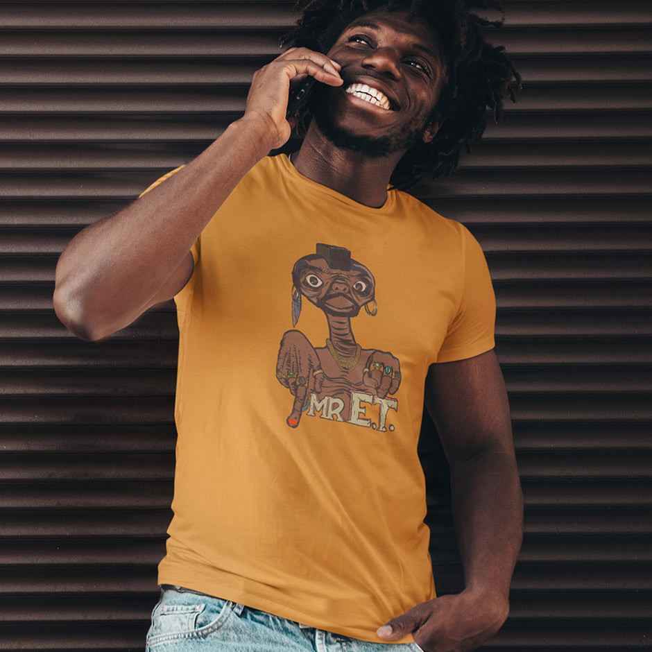 Guy wearing gold retro graphic tees featuring Mr. E.T. movie mashup illustration by Dodo Tees. The 80s t shirt is an ideal white elephant gift exchange present.