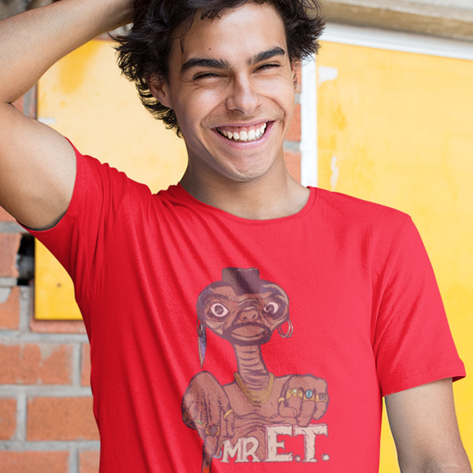 guy wearing retro graphic tees featuring Mr. E.T. movie mashup illustration by Dodo Tees. the 80s t shirt features ET dressed up like Mr. T. 