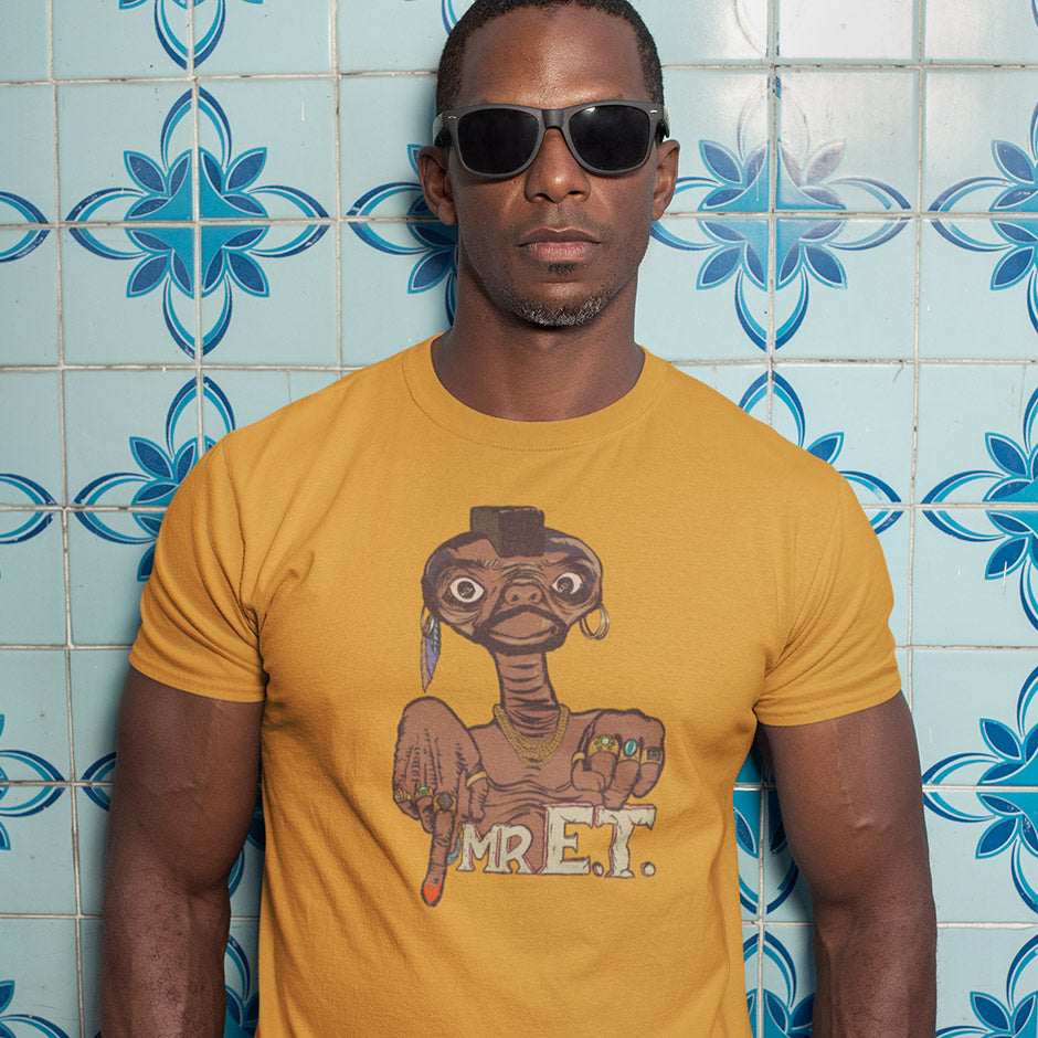 man in a retro vintage t shirt featuring Mr. ET movie mashup. Illustration by Dodo Tees. The vintage style t shirt features ET dressed up like Mr. T complete with gold chain and rings.