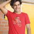 Smiling man wearing a santa shirt that reads Just here for the Ho's and has an original Santa illustration by Dodo Tees