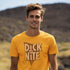 man outside wearing silly t shirt with distressed dick at night logo printed on the front