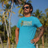 man at beach wearing surfing t shirt with mount kamana wanna lei a graphic