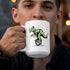 man drinking t rex mug with illustration of a t rex riding a unicycle in the circus