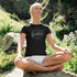 woman meditating in wilderness wearing yoga shirt with practice gratitude design