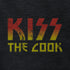 funny t shirt reading kiss the cook. The funny dad shirt features a distressed printing style for that worn in look.