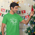 man hanging ornaments wearing mens funny christmas shirt with schweddy balls logo. The Holiday Themed Shirts make Hilarious Stocking Stuffers For Dad.