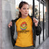 woman in black jacket wearing pride shirt with rainbow sheep of the family illustration