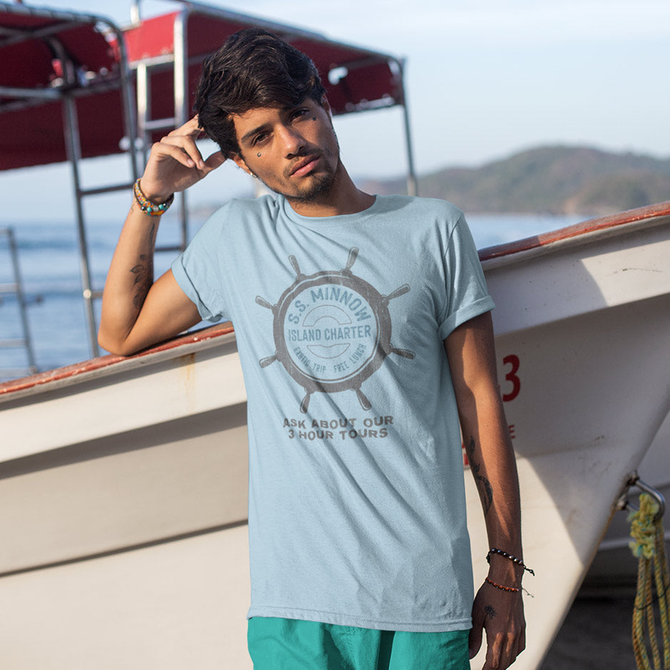 man leaning against boat wearing surfing t shirt with ss minnow logo. The tv show shirts have are side seamed and utilize premium inks and materials.