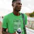 man outside wearing workout t shirt with pickle jar illustration. The green workout shirt comes in sizes S-3XL.